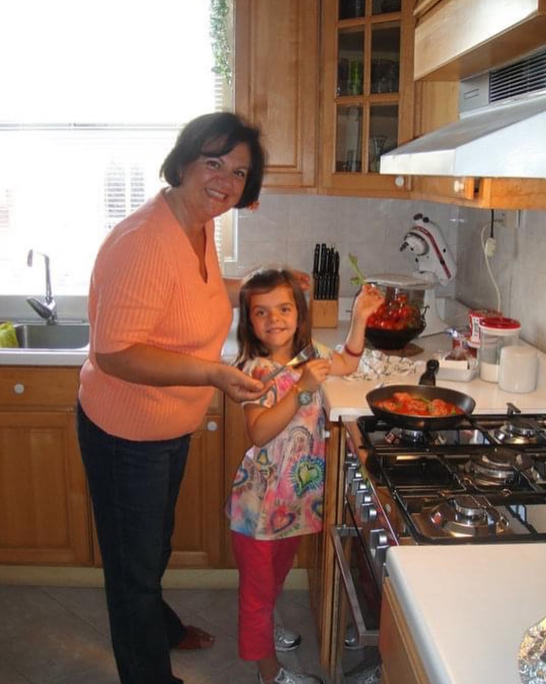 Young Haley cooking meatballs with her grandmother